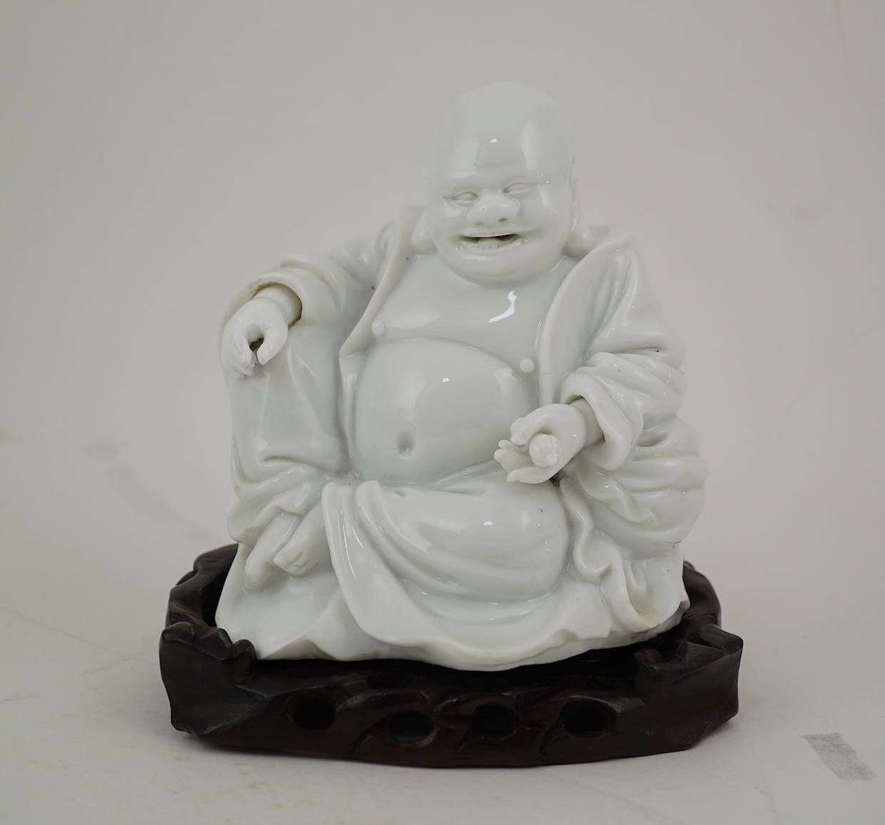 A Chinese blanc-de-chine seated figure of Budai, 18th/19th century